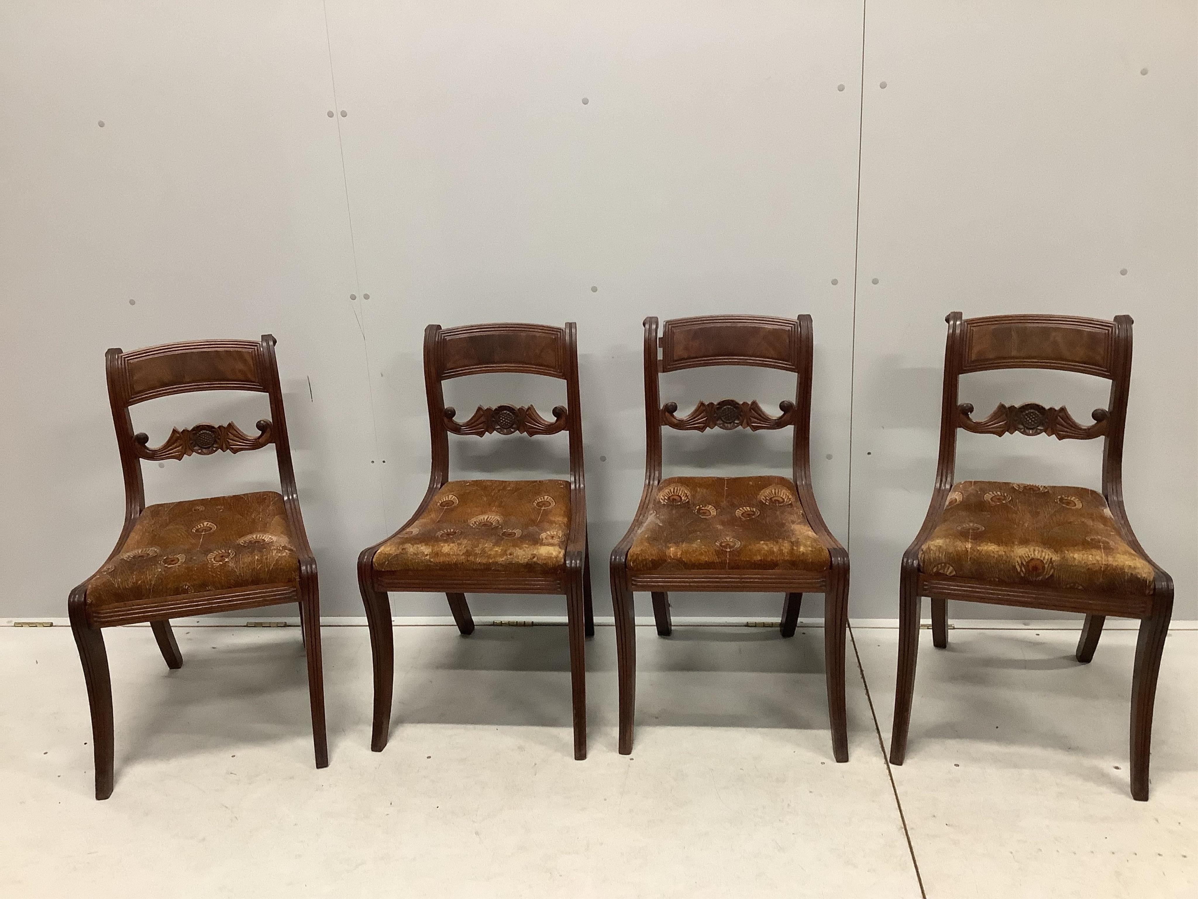 A set of four Regency mahogany dining chairs with sabre legs and roundel spars. Condition - poor to fair